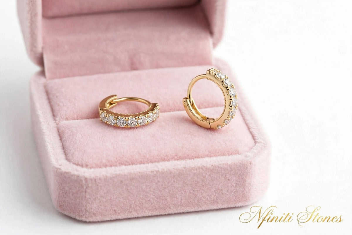 Yellow-finish moissanite hoop earrings in a pink velvet box