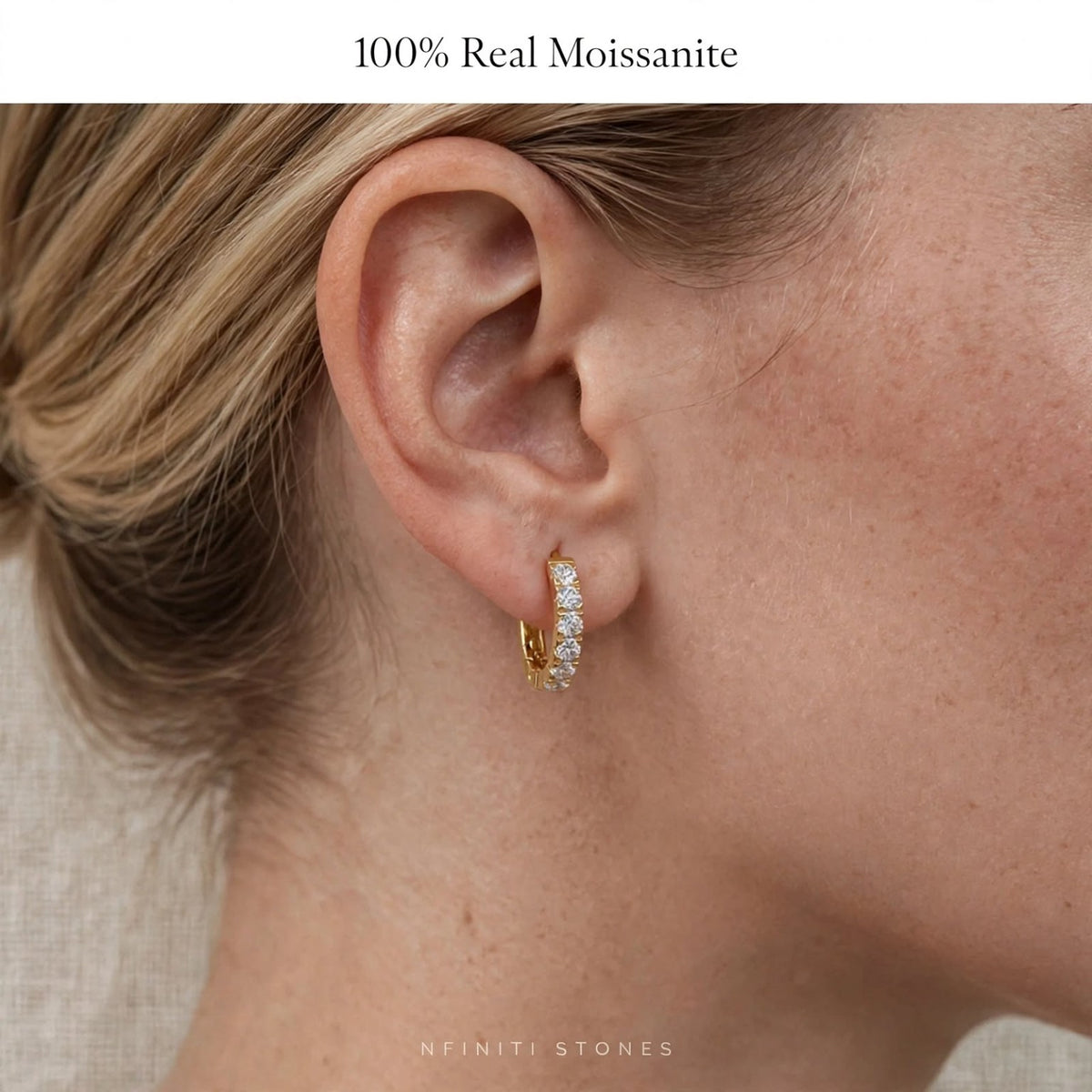 Yellow-finish moissanite hoop earring worn on ear